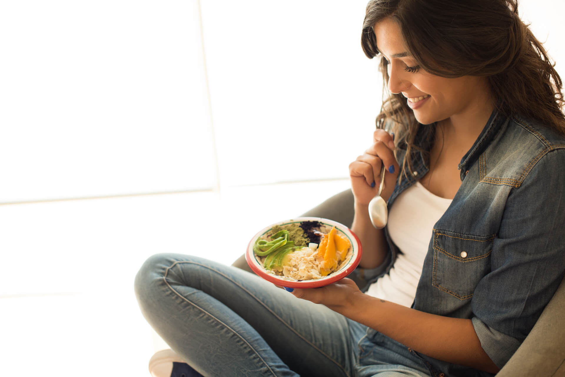 woman-eating-a-healthy-bowl-of-superfoods-2021-09-02-10-31-08-utc